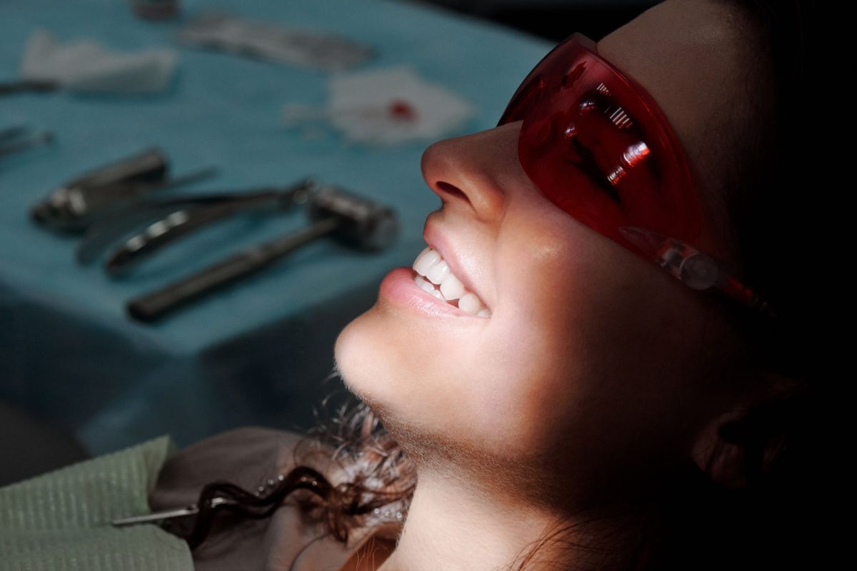 A young professional expat at a modern German dentist office learning about Dental Insurance in Germany