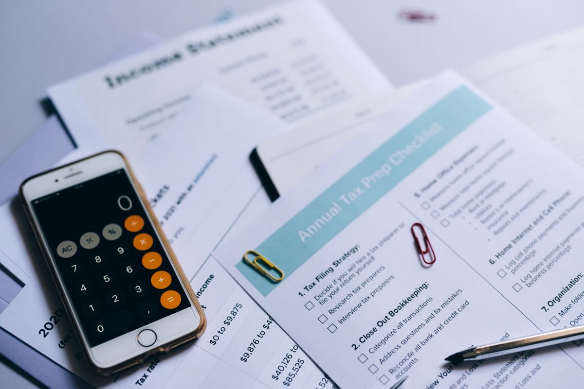 Expat reviewing German tax documents and insurance papers at a desk.